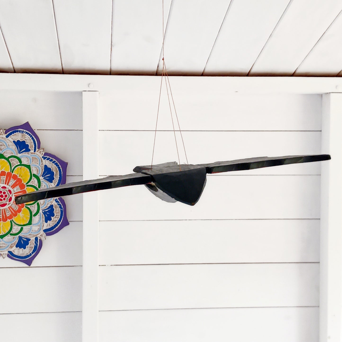 Bring a touch of gothic magic into your home with this striking hand-carved wooden flying bat mobile, handmade by skilled artisans in Bali, Indonesia. With its wings dramatically outstretched to approximately 50cm wide, this unusual hanging decoration makes a bold statement suspended from a ceiling, doorway, window or display area.