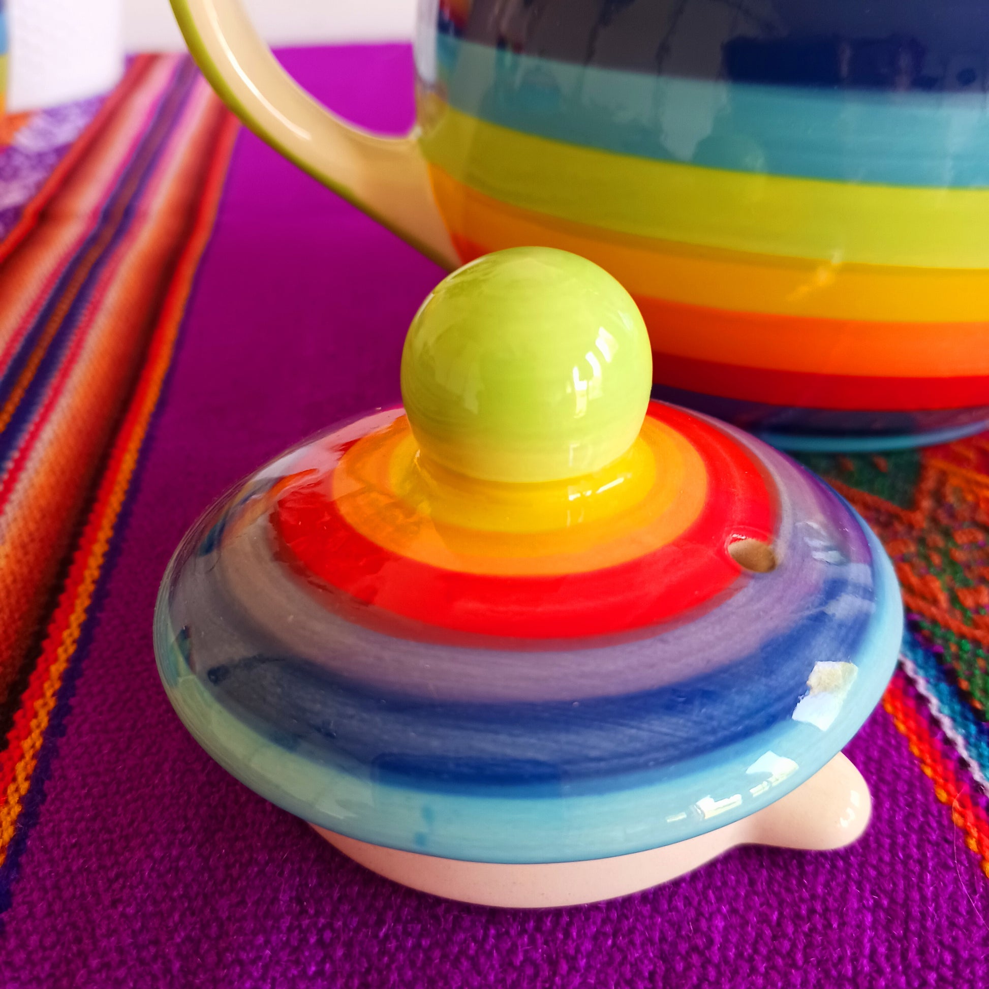 Experience the perfect fusion of artistry and functionality with this exquisite 2-cup ceramic teapot from Thailand. Handcrafted by skilled artisans, this vibrant teapot features a stunning rainbow stripe, adding a pop of colour and charm to your tea rituals.
