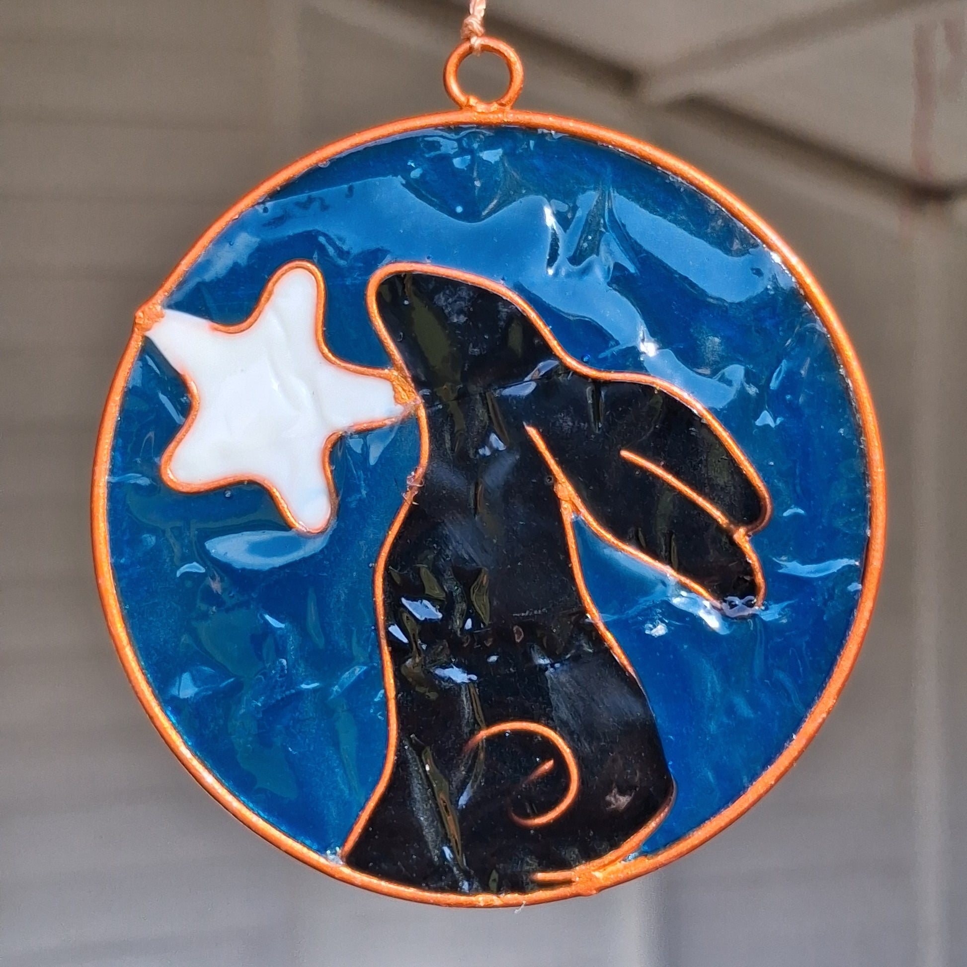 Invite the mystical energy of nature into the home with this little pagan suncatcher featuring a moon gazing hare and moon design. Handcrafted in Bali, this enchanting piece is sure to infuse any space with a touch of earthly charm.