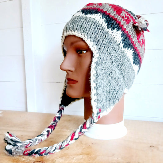 Stay cozy and stylish with our handmade chunky wool earflap hats, crafted in Nepal by skilled women artisans in Kathmandu. Each hat is 100% pure wool and features a soft polar fleece lining for extra warmth and comfort. Perfect for cold winter days, outdoor adventures, or adding a touch of handmade charm to your look.