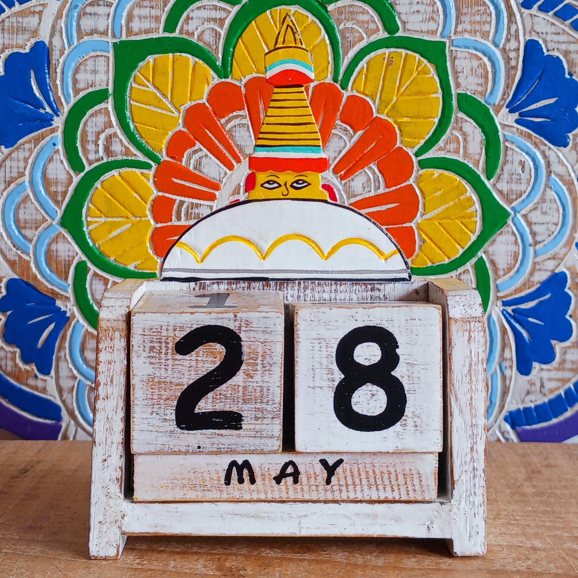 Bring a sprinkle of harmony to your everyday routine with the Nepal Stupa Wooden Calendar. Crafted from lightweight, durable wood, this enchanting piece combines functionality with fairy-tale charm. Each day, simply rotate the wooden blocks to keep track of the date—no need for replacements, making it a timeless addition to your home or office.