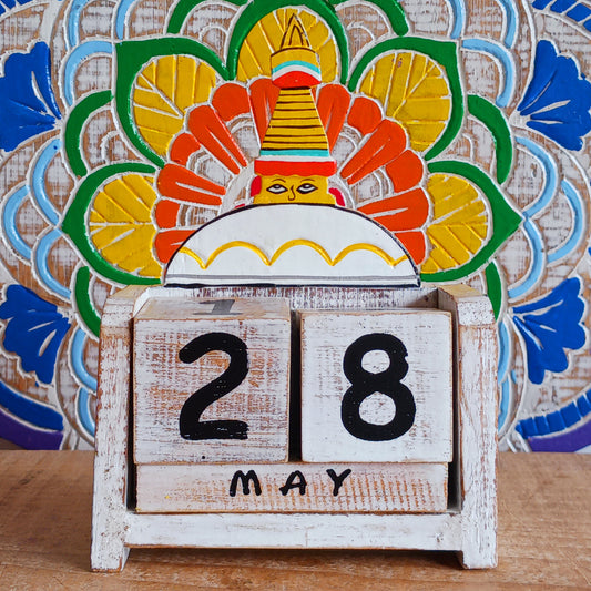Bring a sprinkle of harmony to your everyday routine with the Nepal Stupa Wooden Calendar. Crafted from lightweight, durable wood, this enchanting piece combines functionality with fairy-tale charm. Each day, simply rotate the wooden blocks to keep track of the date—no need for replacements, making it a timeless addition to your home or office.