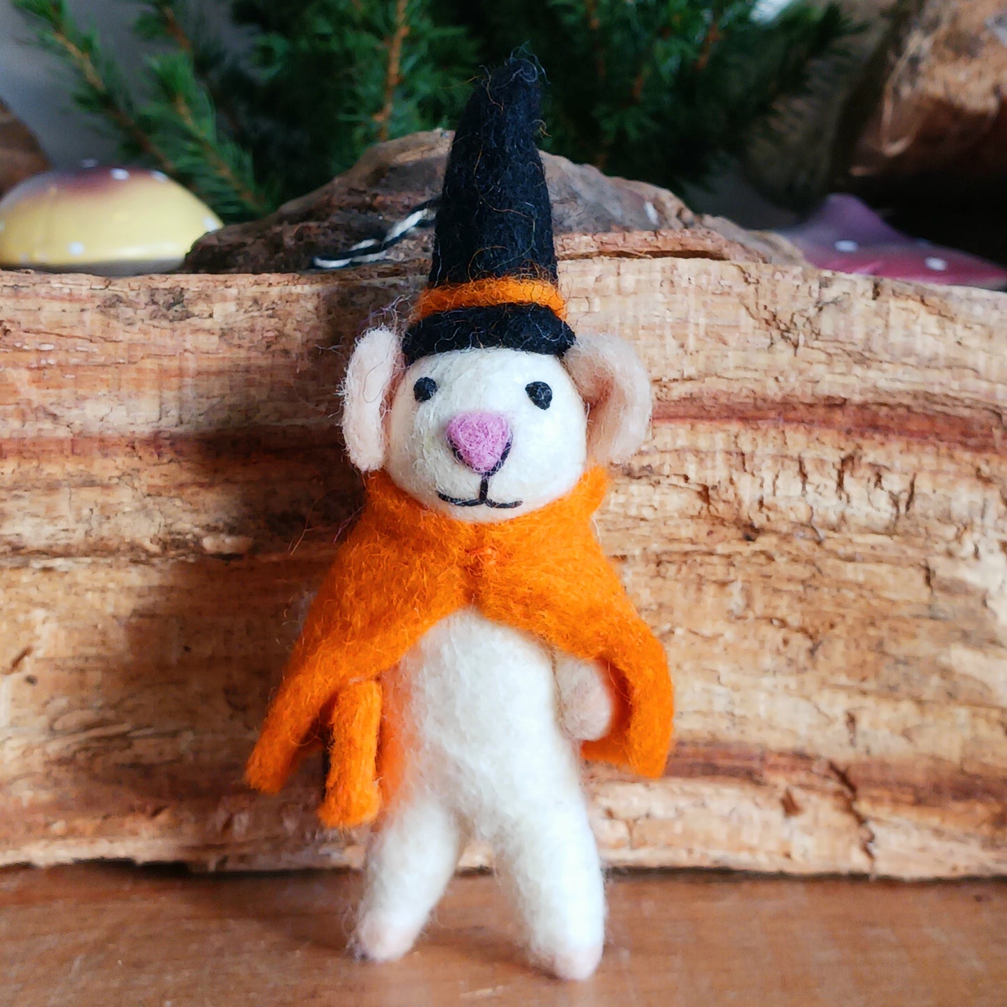 Bring a touch of handcrafted Halloween charm to your home with these delightful felted mice dressed as a playful “Boo” character. Each mouse features adorable details including long tails, soft pink ears and noses, and colourful pointed hats and capes. These little mice have a “Boo” sign—and comes with a black-and-white hanging thread, perfect for decorating branches, hooks, garlands, or spooky seasonal displays.