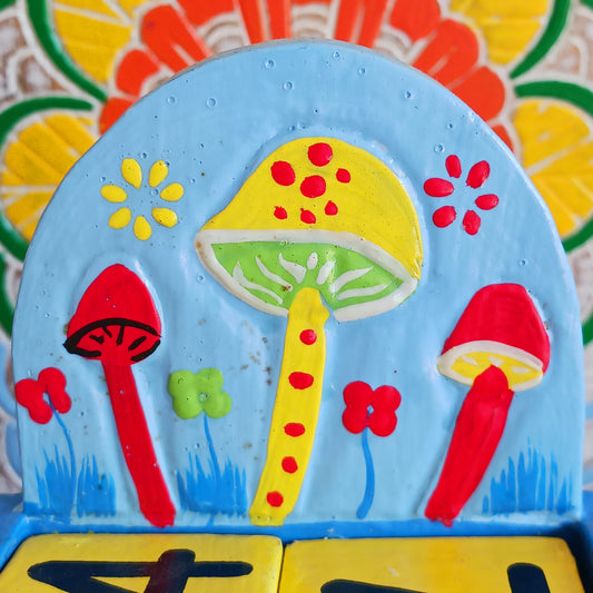 Bring a touch of whimsy and eco-friendly charm to your desk with this hand-painted wooden mushroom perpetual calendar. Perfect for your work, study, or creative space, this fun desk accessory makes organizing your days delightful. Simply rotate the wooden blocks to update the date—no waste, no replacement pages, just timeless functionality you can enjoy year after year. A thoughtful, sustainable gift for nature lovers, students, and anyone who enjoys a touch of woodland magic in their daily routine.