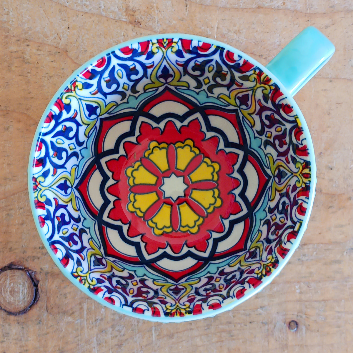 Bring the warmth and colour of the Mediterranean into your home with this beautiful Tuscany-inspired ceramic mug. Featuring a vibrant glazed exterior and an eye-catching embossed geometric pattern inside, this stylish mug is inspired by the rustic terracotta tiles and intricate murals found in sun-soaked Italian villages.