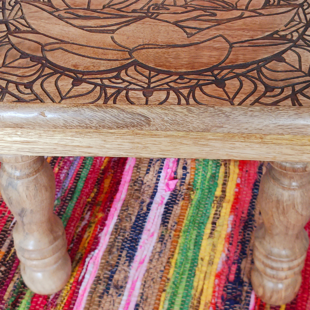 Bring peace and tranquillity to your home with this beautiful handcrafted mango wood table, featuring an intricately carved Buddha and Lotus Flower design on the tabletop. Combining traditional craftsmanship with spiritual symbolism, this unique wooden table makes a wonderful addition to a meditation space, Buddhist altar, yoga room or peaceful home sanctuary.