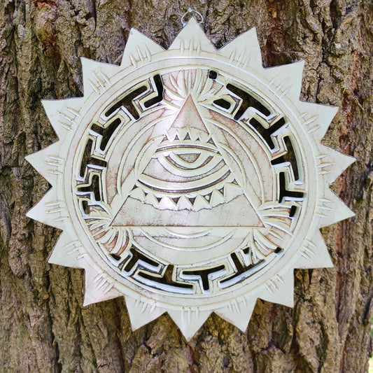 This wooden plaque has been intricately carved by hand to represent the Eye of Providence. The Eye of Providence or All-Seeing Eye is a symbol depicting an eye, often enclosed in a triangle and surrounded by a ray of light or a halo, intended to represent Providence, as the eye watches over the workers of mankind. In Christianity it serves as a reminder that humanitiy's thoughts and deeds are always obserbed by God.