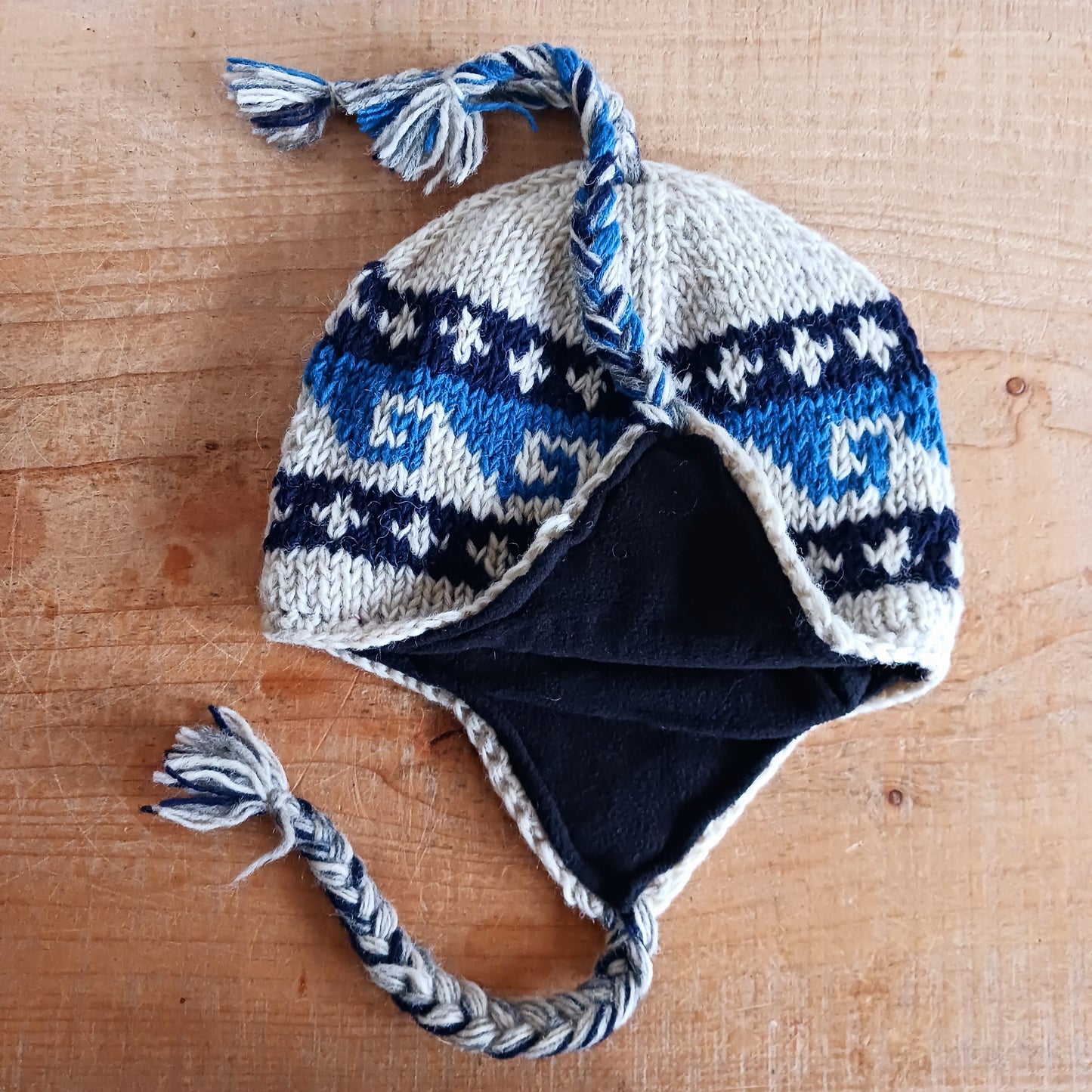 Stay cozy and stylish with our handmade chunky wool earflap hats, crafted in Nepal by skilled women artisans in Kathmandu. Each hat is 100% pure wool and features a soft polar fleece lining for extra warmth and comfort. Perfect for cold winter days, outdoor adventures, or adding a touch of handmade charm to your look.