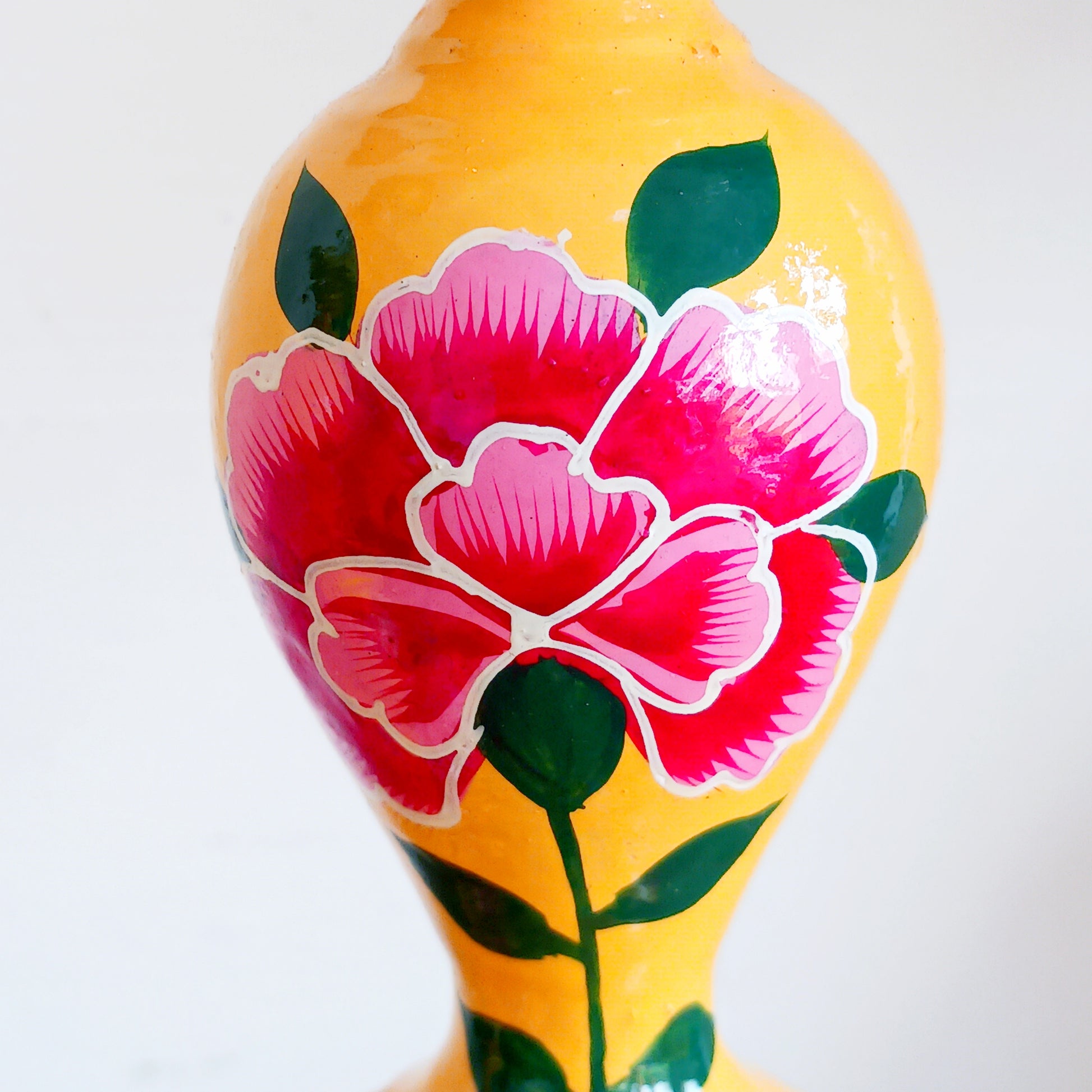 Add warmth, colour, and artisan beauty to your home with these hand painted yellow wooden candlesticks, beautifully crafted from sustainably sourced wood. Each piece is carefully painted by skilled artisans and decorated with elegant chrysanthemum flowers, a symbol of positive life forces including love, appreciation, longevity, happiness, and optimism.
