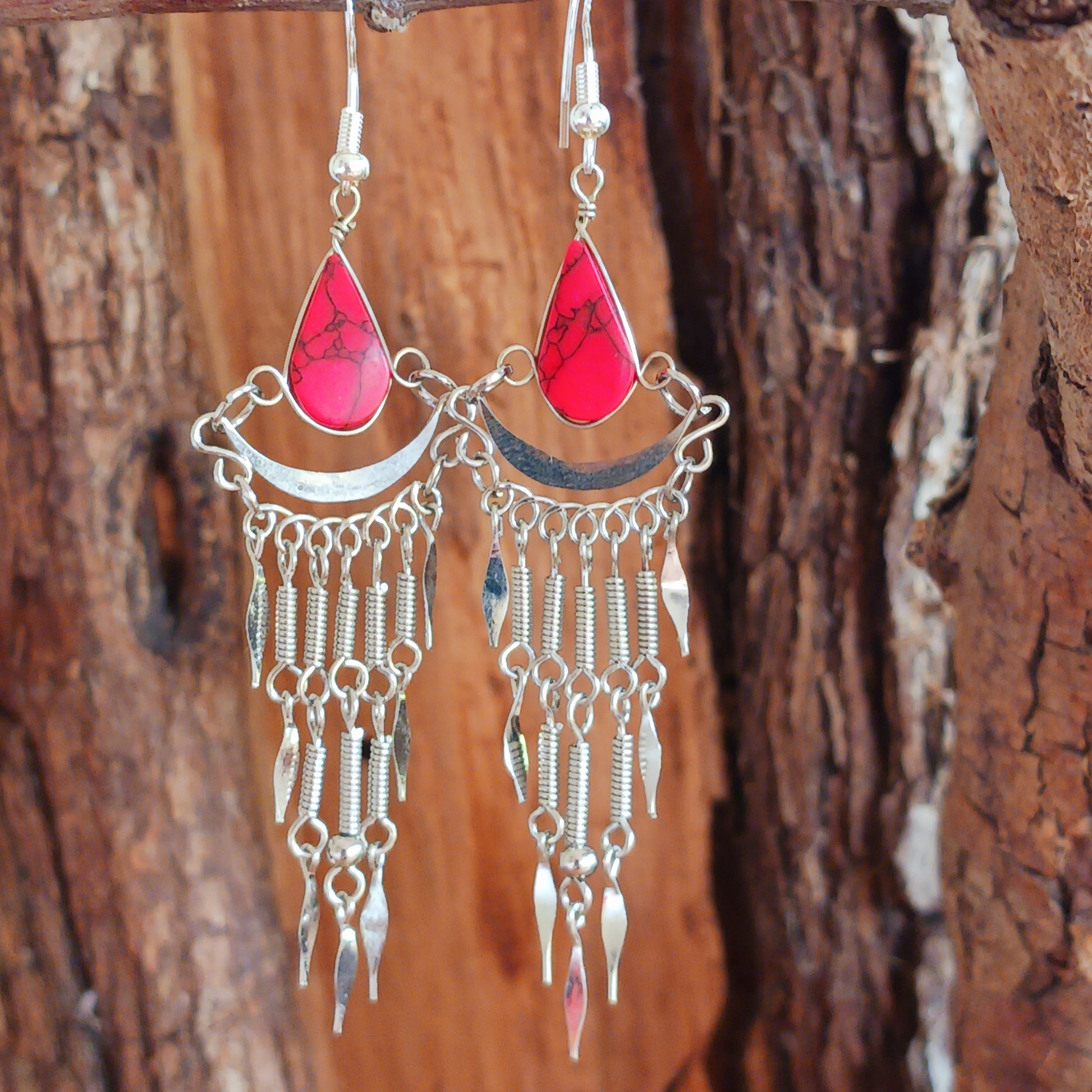 Add a touch of bohemian beauty to your look with these handmade Peruvian stone earrings. Featuring red stones and finished with silver-plated hooks, each pair is carefully crafted in small workshops in Peru.