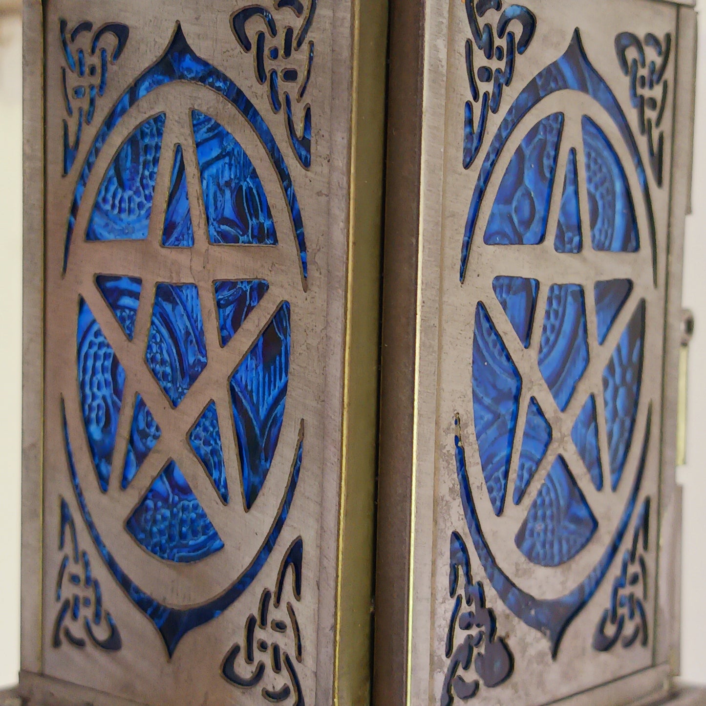 Bring warmth, colour and spiritual harmony to your home with this beautiful Pentagram Glass Lantern. Designed with vibrant coloured glass panels and a decorative metal cut-out canopy, this lantern creates a calming glow that enhances meditation spaces, yoga rooms and home décor.