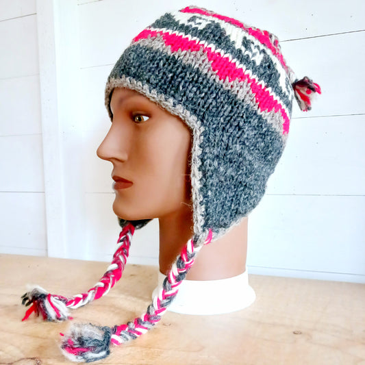 Stay cozy and stylish with our handmade chunky wool earflap hats, crafted in Nepal by skilled women artisans in Kathmandu. Each hat is 100% pure wool and features a soft polar fleece lining for extra warmth and comfort. Perfect for cold winter days, outdoor adventures, or adding a touch of handmade charm to your look.