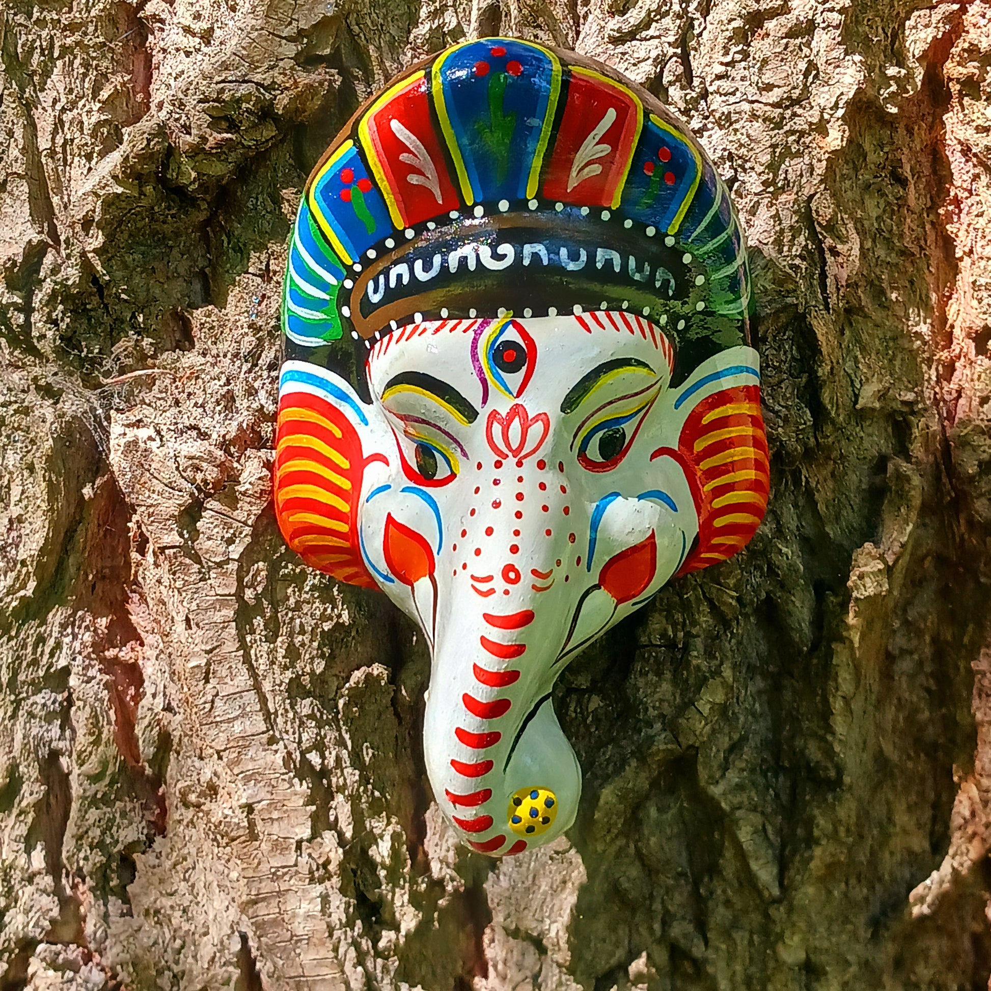 Bring the blessings of Ganesh into your home with this handcrafted terracotta mask from Nepal. Known as the remover of obstacles and the deity of wisdom, learning, and new beginnings, Ganesh is one of the most beloved figures in Hindu tradition. His elephant head and gentle features are beautifully captured in this spiritual wall hanging.