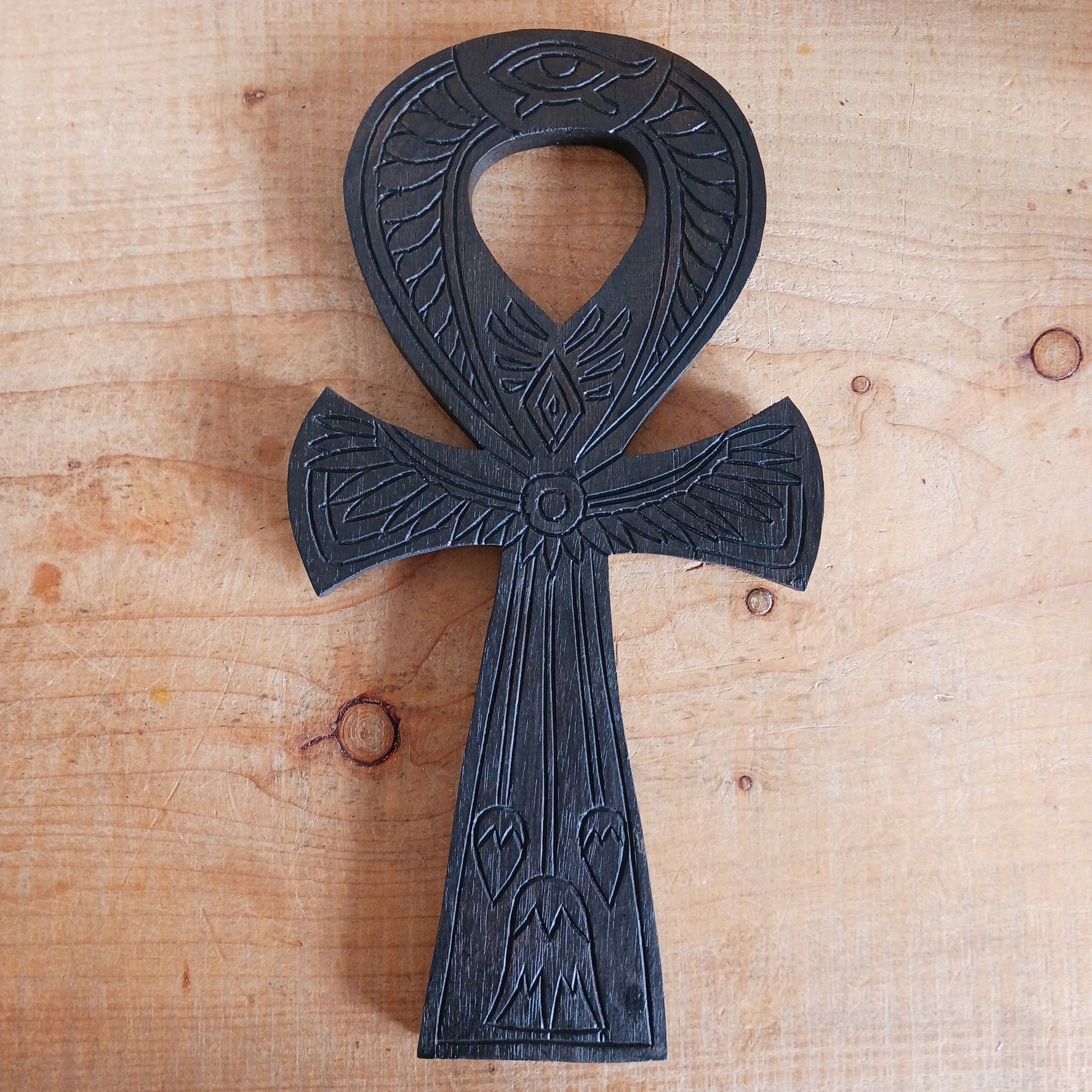 This beautiful and intricately carved wall plaque features a traditional symbol of the ancient Egyptians. The ankh is often interpreted as a symbol of life and eternal existence. Its looped top is thought to represent the eternal soul, while the straight line below symbolises the earthly plane or physical existence. Together, they signify the eternal cycle of life, death, and rebirth.