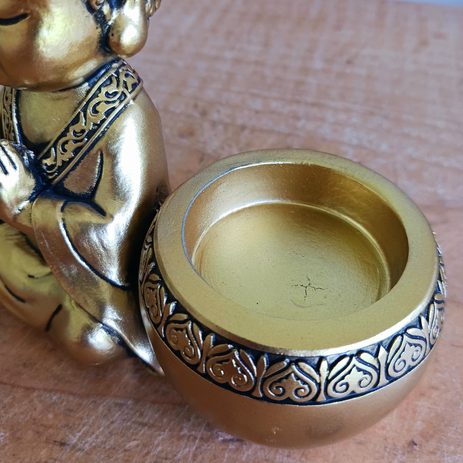 Bring a sense of peace and mindfulness into your home with this elegant Gold Buddha Tealight Candle Holder. Featuring a beautifully crafted praying Buddha figure alongside a tealight holder, this decorative piece creates a calming ambiance wherever it is placed.