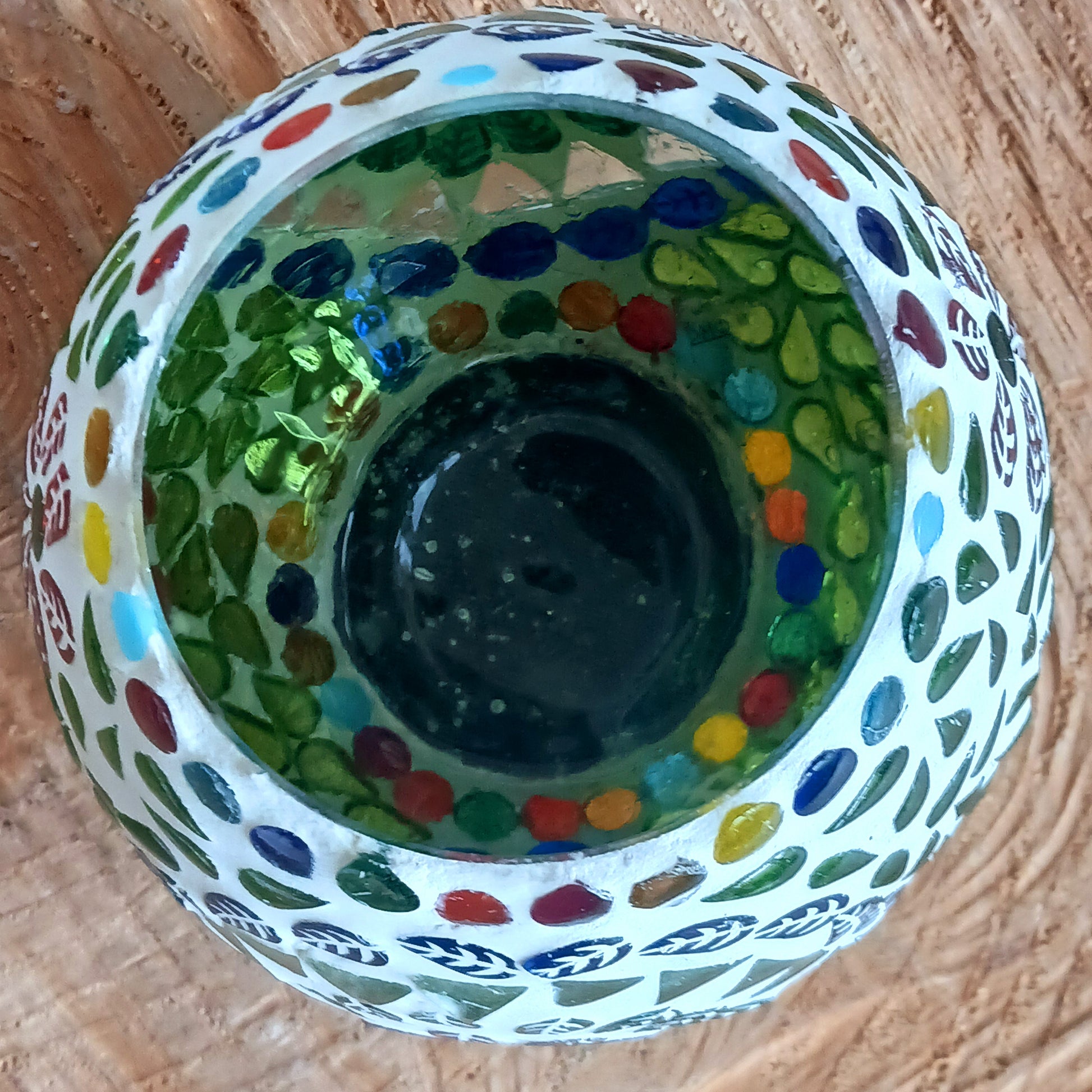 These beautiful tealight holders are a mosaic mixture of pearlescent and block colours that create a vibrant floral mandala design on this glass tealight holder. Pop in a lit tealight to warm the atmosphere with multi colour vibes on outdoor summer evenings, or indoors to brighten the long dark evenings.