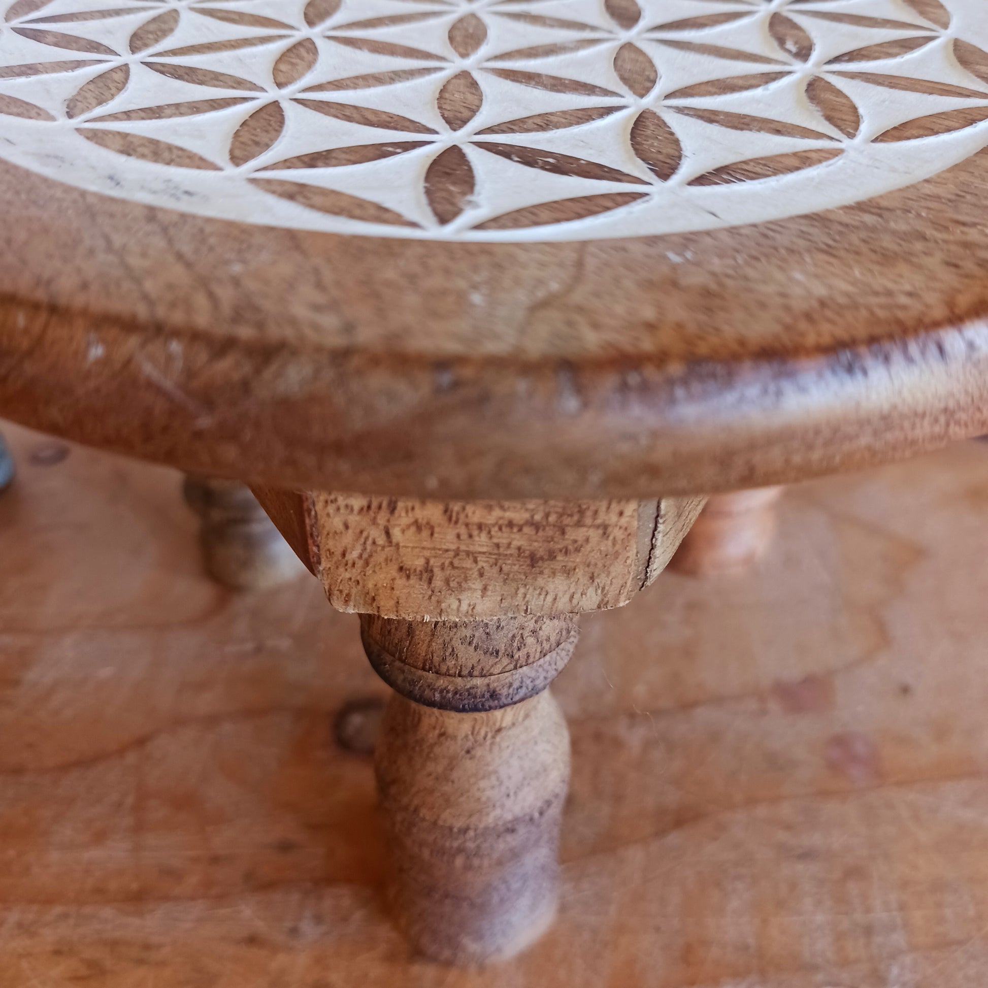 Bring the beauty of sacred geometry into your space with these compact Flower of Life tables. Handcrafted from solid mango wood, each table features a finely engraved Flower of Life symbol on top – an ancient pattern representing the interconnectedness of all life. 