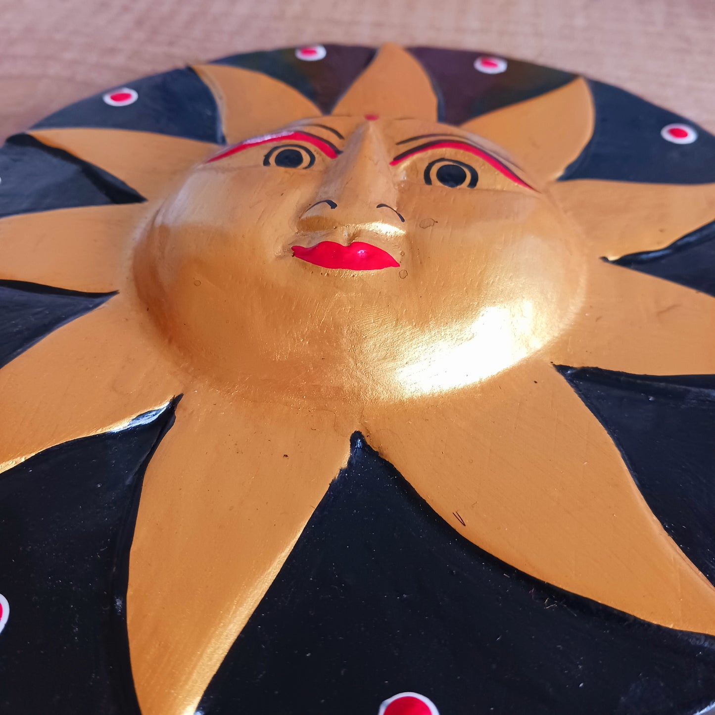 Bring a burst of sunshine into your home with this Black and Gold Sun Plaque, lovingly hand-carved in Bali from sustainably sourced wood. Each plaque features a radiant sun face surrounded by detailed rays, symbolizing warmth, vitality, and the cycles of life.
