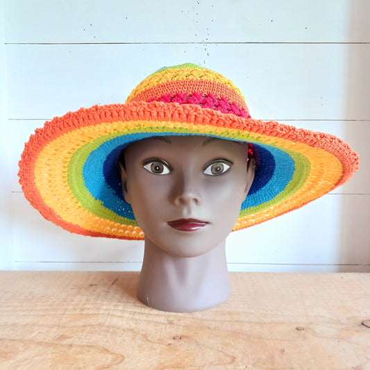 Brighten up your summer with this vibrant handmade crochet cotton sun hat! Featuring a stunning rainbow pattern, this unique hat is perfect for holidays, beach days, and festivals. A malleable wire is carefully woven into the rim, allowing you to shape the brim just how you like it. Lightweight and breathable, it's ideal for sunny adventures. Each hat is individually handcrafted, so you’ll receive the exact one pictured – a one-of-a-kind accessory to celebrate the season in style.