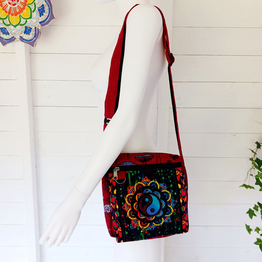 This lovely Yin Yang shoulder bag is both practical and unusual. There are three zipped compartments ensuring you keep your valuables safe. The Yin Yang design on the front is set in a colourful mandala on the flap, and this is secured with a velcro strips. The staps are adjustable to suit your style.