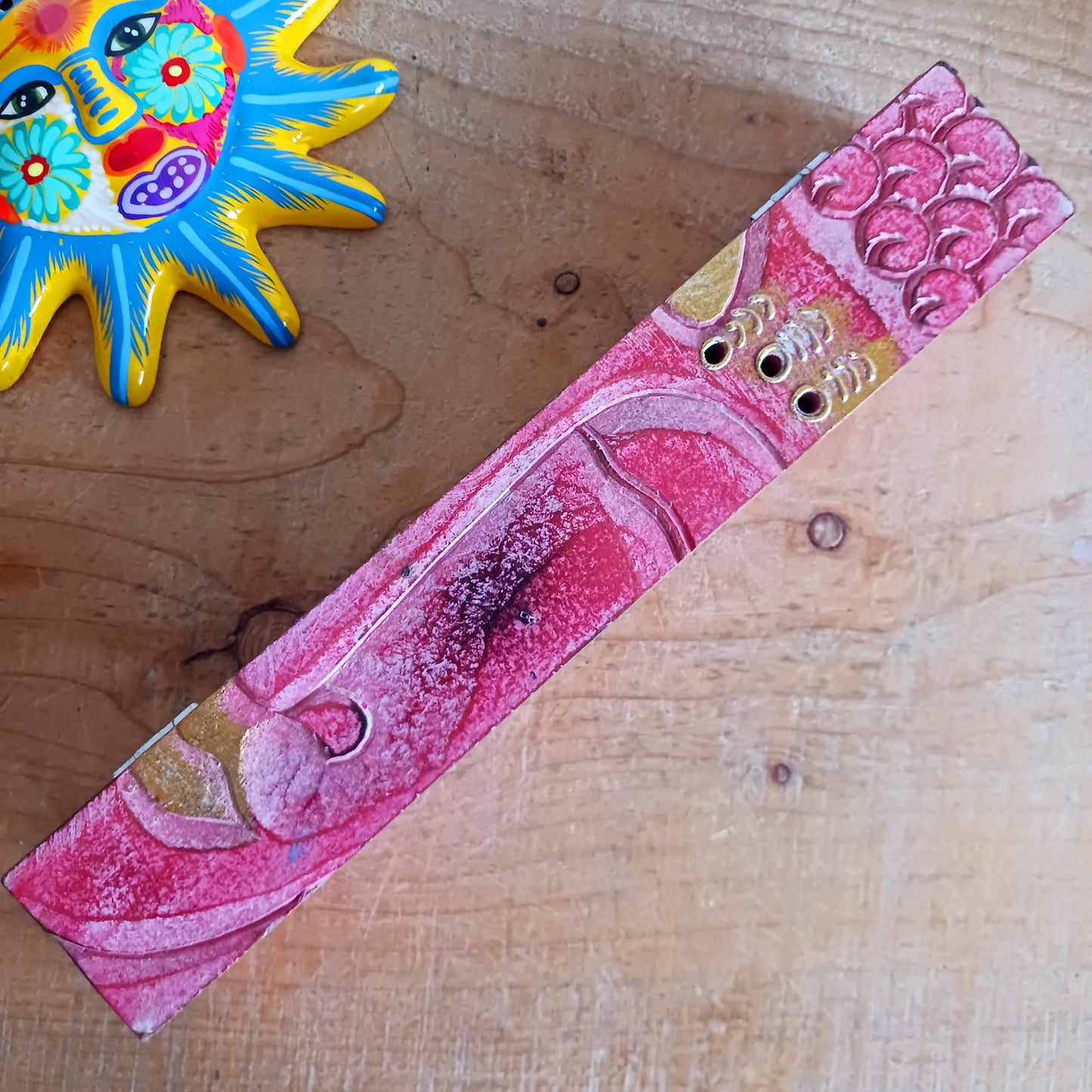 This unique incense stick holder is perfect to catch the ash from your favourite incense. It has been handmade from responsibly sourced wood and beautifully decorated with a handcarved Buddha head.