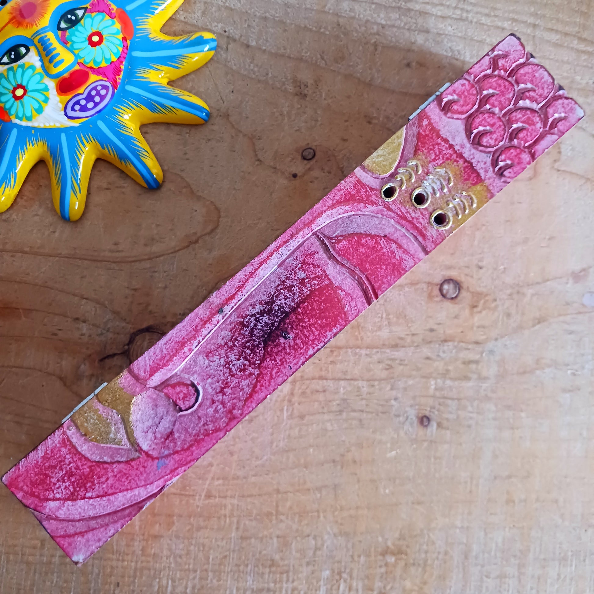 This unique incense stick holder is perfect to catch the ash from your favourite incense. It has been handmade from responsibly sourced wood and beautifully decorated with a handcarved Buddha head.