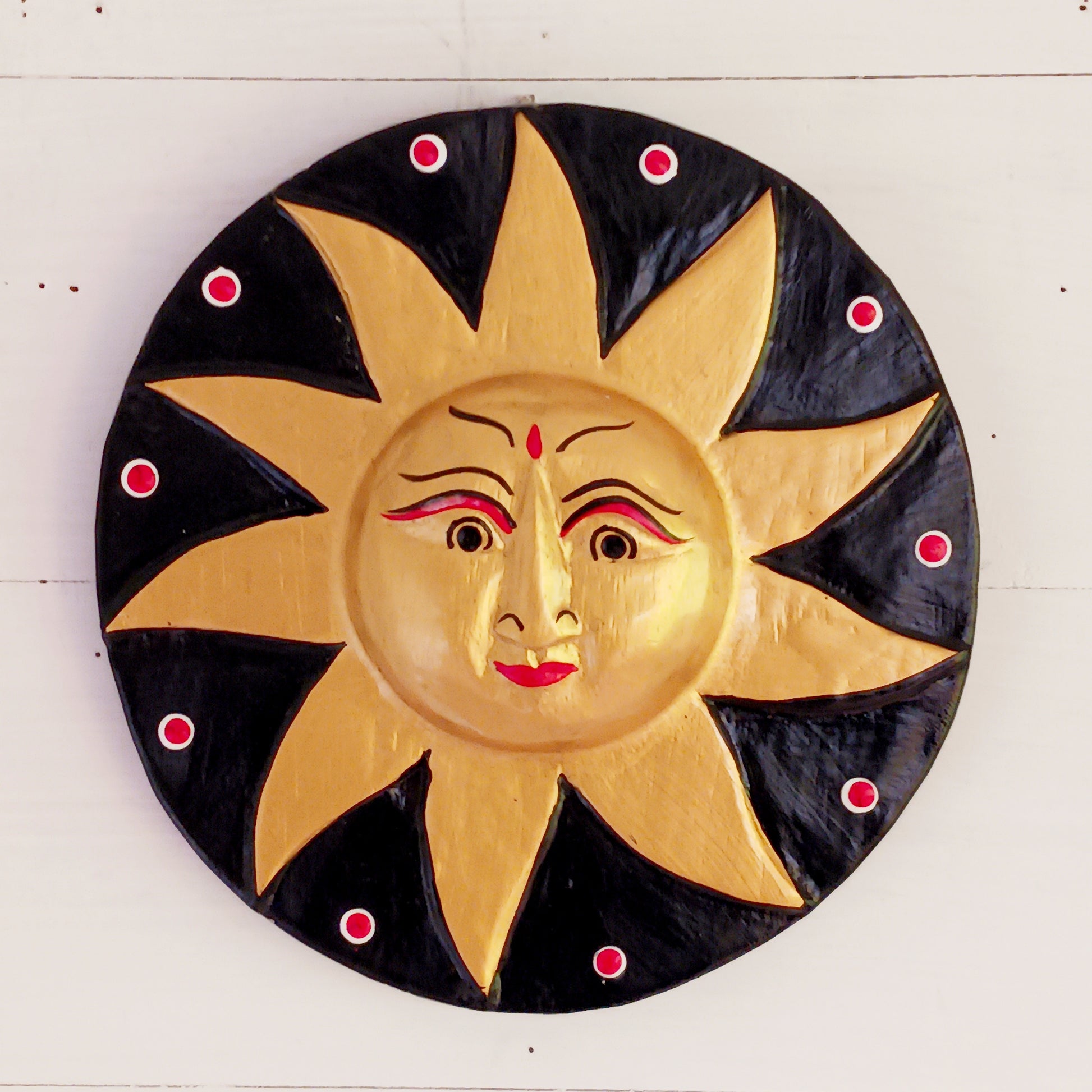 Bring a burst of sunshine into your home with this Black and Gold Sun Plaque, lovingly hand-carved in Bali from sustainably sourced wood. Each plaque features a radiant sun face surrounded by detailed rays, symbolizing warmth, vitality, and the cycles of life.