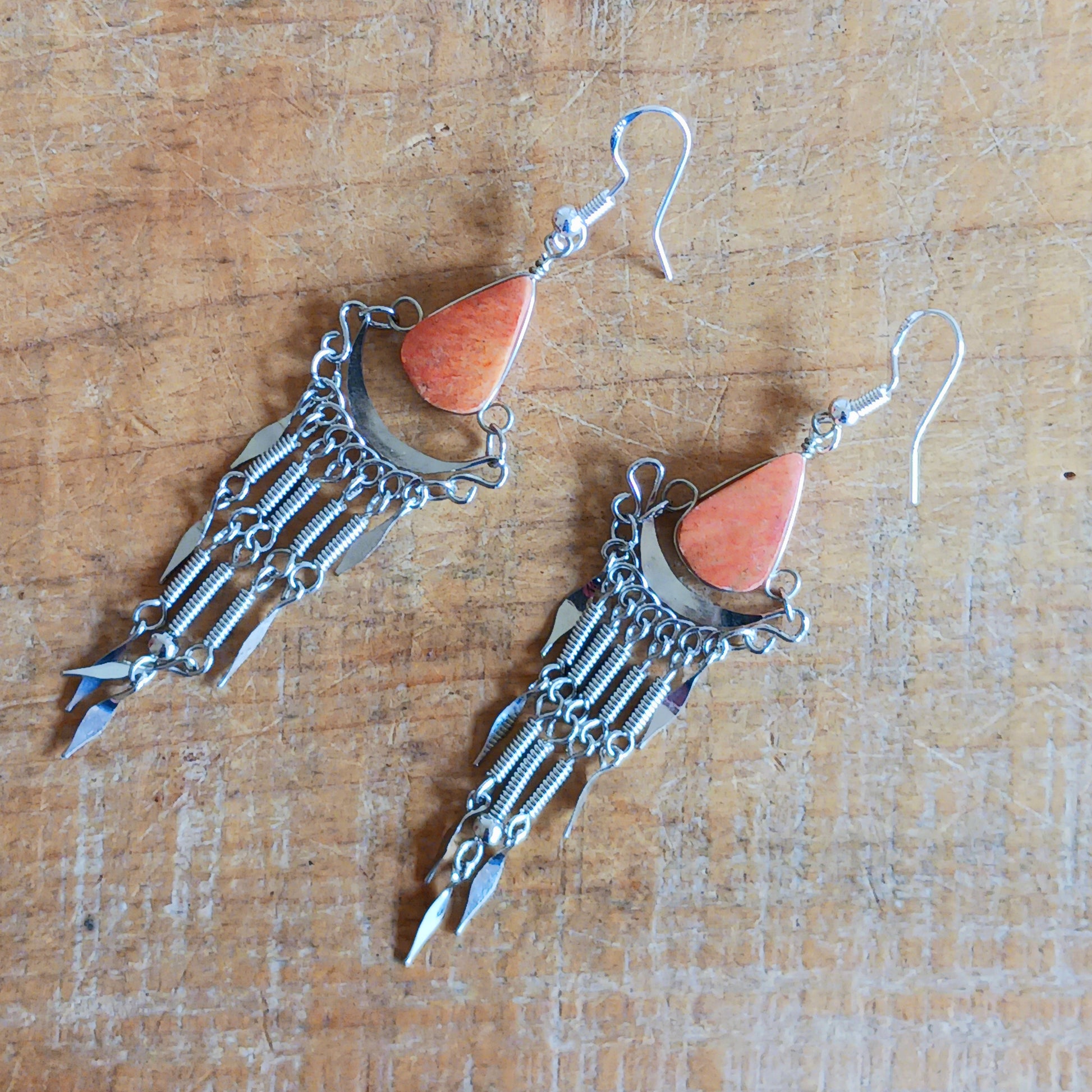 Add a touch of bohemian beauty to your look with these handmade Peruvian stone earrings. Featuring orange stones and finished with silver-plated hooks, each pair is carefully crafted in small workshops in Peru.