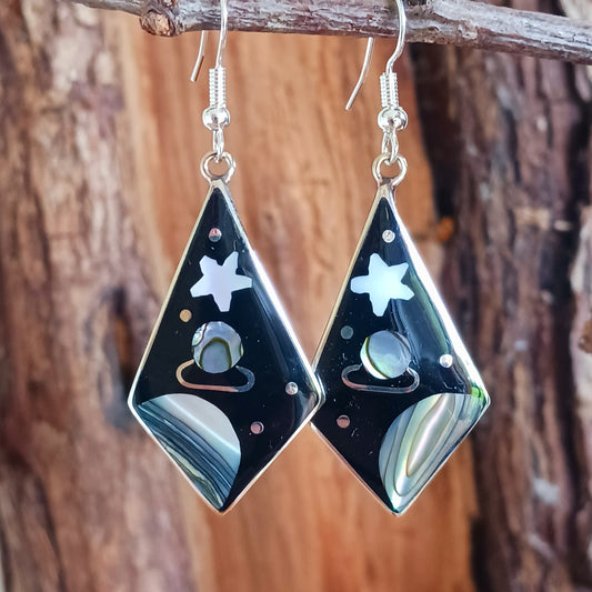 These large diamond shaped earrings feature a cosmic space scene of stars, moons and the planet Saturn crafted from mesmerising abalone shell.
