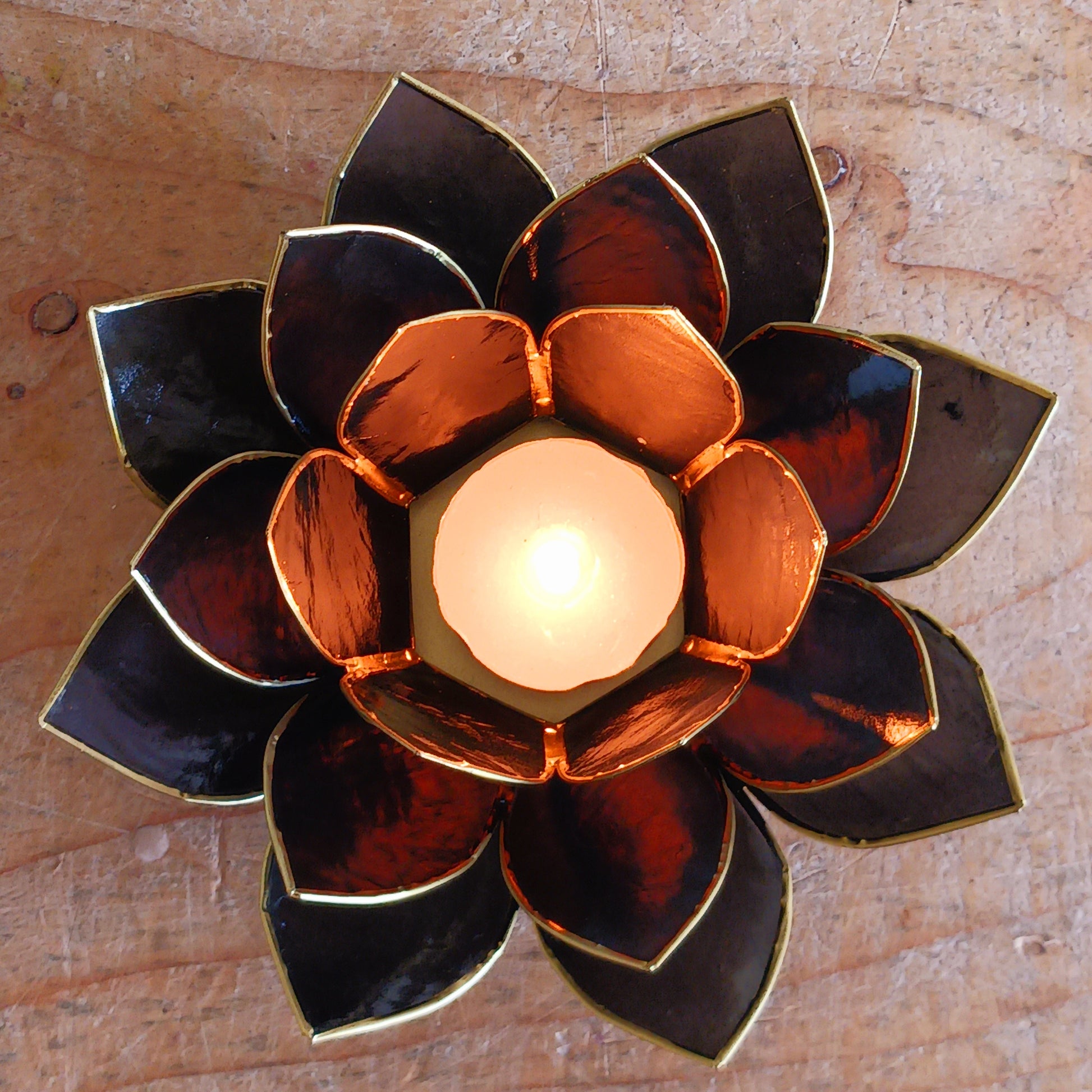 The Lotus Flower is a symbol of achieving enlightenment, peacefulness and spirituality. This beautiful candle holder can be fitted with tealight candles or slightly larger candles. The diameter of the middle is roughly 5.5cm, so it will fit any candle with the same diameter.