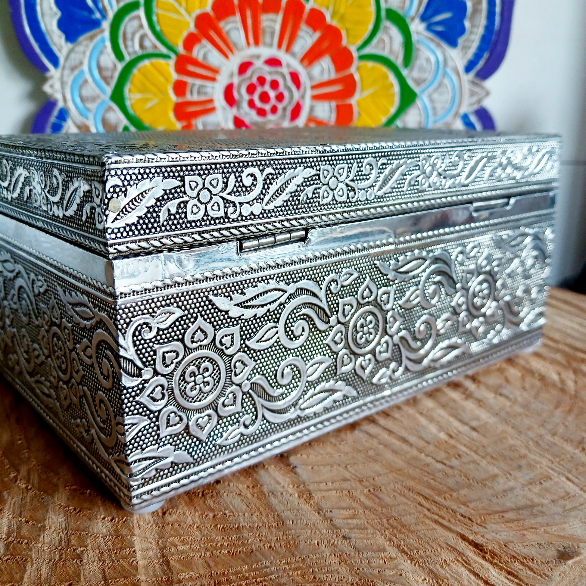 This beautiful silver colour embossed aluminium jewellery box has plenty of space for you to keep you jewellery and other valueables, and comes with a pull-out drawer.  It is lined with black cotton velvet and intricately decorated with a hamsa hand on the lid, and ornate bordering.