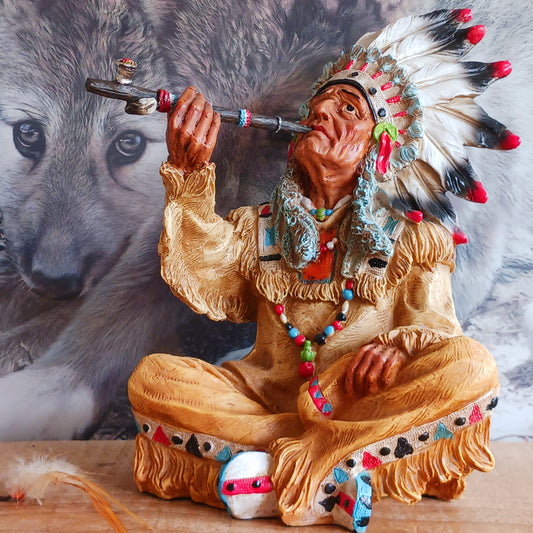 Elevate your space with the serene elegance of this Native American Chief Smoking a Peace Pipe figurine, a captivating symbol of wisdom and cultural harmony. Expertly crafted with intricate detail, this masterpiece depicts a noble chief in traditional tribal attire, smoking a symbolic peace pipe with grace and dignity. From the regal feathered headdress to the delicate carving of the pipe, every element reflects the artistry and cultural depth of Native American traditions. 