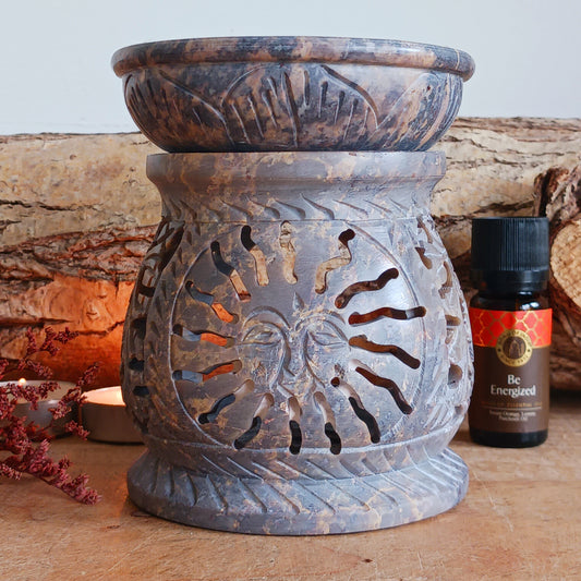 Enhance your home with calming fragrance and natural style with this beautifully carved soapstone oil burner. Featuring an elegant central sun motif with detailed leaf designs, this decorative aromatherapy burner adds warmth, ambience, and relaxing scent to any room.