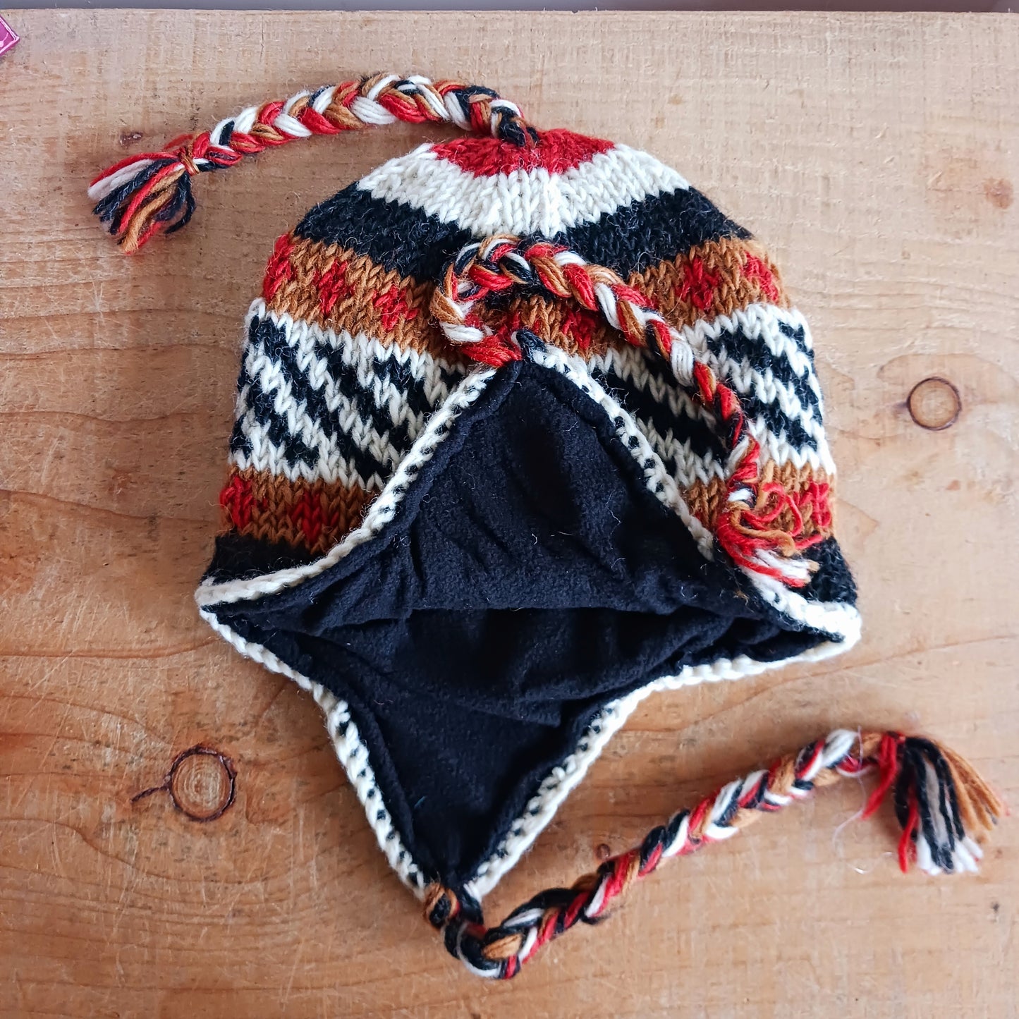 Stay cozy and stylish with our handmade chunky wool earflap hats, crafted in Nepal by skilled women artisans in Kathmandu. Each hat is 100% pure wool and features a soft polar fleece lining for extra warmth and comfort. Perfect for cold winter days, outdoor adventures, or adding a touch of handmade charm to your look.