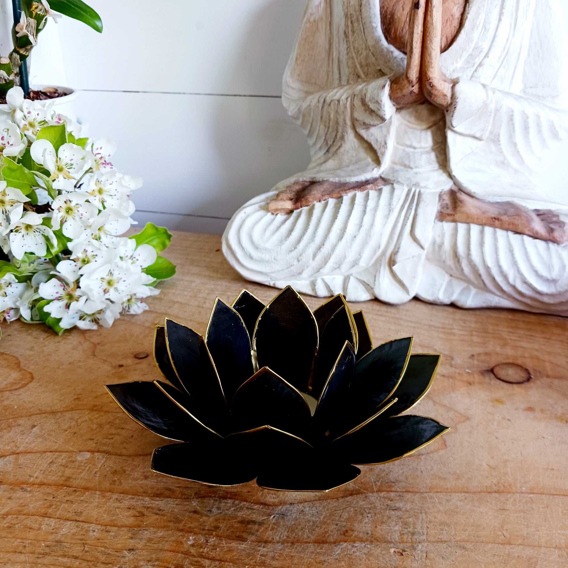 The Lotus Flower is a symbol of achieving enlightenment, peacefulness and spirituality. This beautiful candle holder can be fitted with tealight candles or slightly larger candles. The diameter of the middle is roughly 5.5cm, so it will fit any candle with the same diameter.