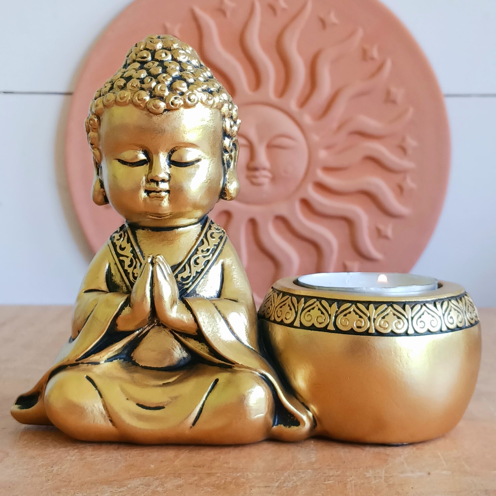 Bring a sense of peace and mindfulness into your home with this elegant Gold Buddha Tealight Candle Holder. Featuring a beautifully crafted praying Buddha figure alongside a tealight holder, this decorative piece creates a calming ambiance wherever it is placed.