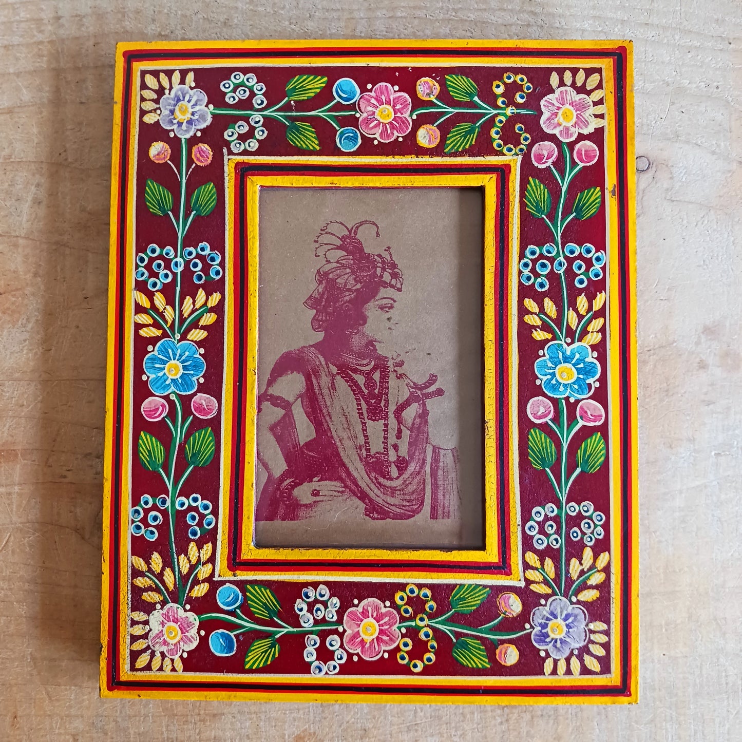 Add a touch of artisan charm to your home with this beautifully handcrafted mango wood photo frame. Made from sustainably sourced mango wood, each frame is carefully hand painted by skilled Indian artisans, featuring vibrant floral patterns that create a stunning tapestry of colour.