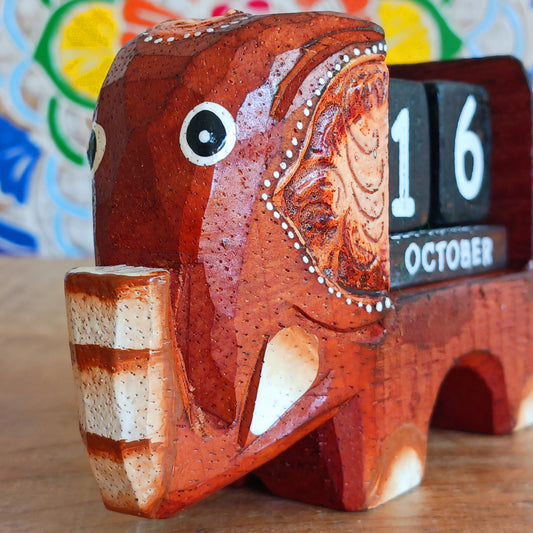 Brighten up your desk with this charming hand-painted wooden elephant calendar! This cheerful desk-buddy is both practical and eco-friendly, making it a perfect addition to your work or study space. Simply rotate the wooden blocks each day to keep track of the date – no need to replace it year after year. A thoughtful, sustainable gift for elephant lovers, students, or anyone who enjoys unique handcrafted décor.