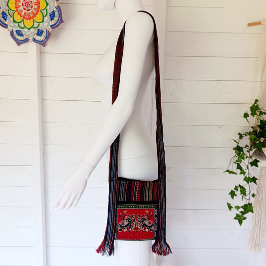 This handy little shoulder bag has a wide strap that is long enough to use as a shoulder or crossbody bag and also makes it comfortable to wear for long periods. The main fabric is traditional with a beautiful embroidered decorated elephants on the front. The bag is finished with tassels.