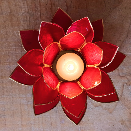 Illuminate your space with the peaceful elegance of our Capiz Shell Lotus Flower Candle Holder. Symbolizing enlightenment and serenity, this stunning handcrafted piece features delicate red petals edged in gold, forming the iconic lotus shape. 