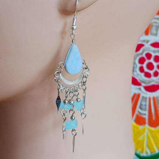 Add a touch of bohemian beauty to your look with these handmade Peruvian stone earrings. Featuring pale blue stones and finished with silver-plated hooks, each pair is carefully crafted in small workshops in Peru.