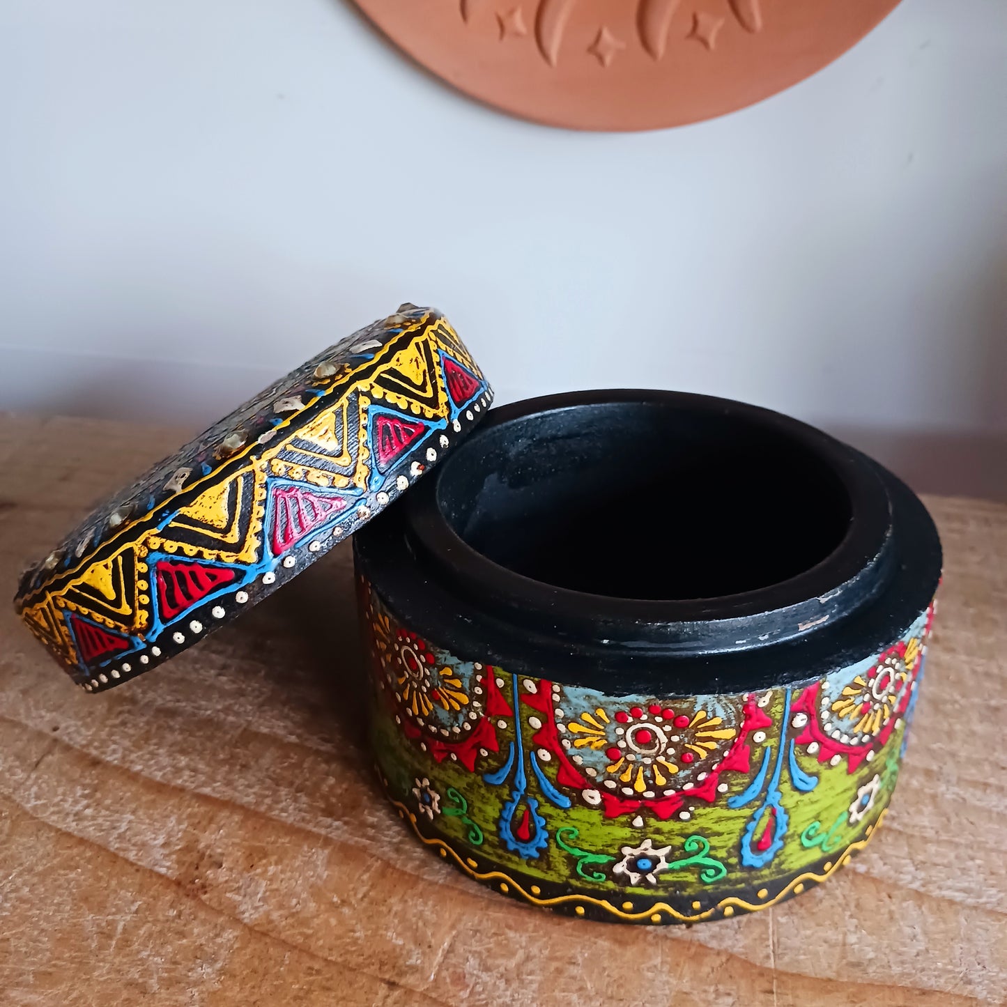 Add a touch of artisan charm to your home with this beautifully hand painted round wooden lidded box, featuring intricate patterns in vibrant colours. Carefully handcrafted in India, each decorative box is uniquely detailed, making it a truly special keepsake.