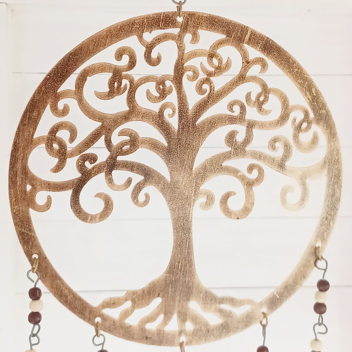 Bring the timeless symbolism of the Tree of Life to your home with this beautiful Tree of Life windchime.  Made in India from quality brass, this 25 cm chime features a beautifully detailed Tree of Life design, adorned with Indian beads. Each branch of the tree is a reminder of growth, connection, and harmony, while the soothing sounds of the bells offer peace to any space.