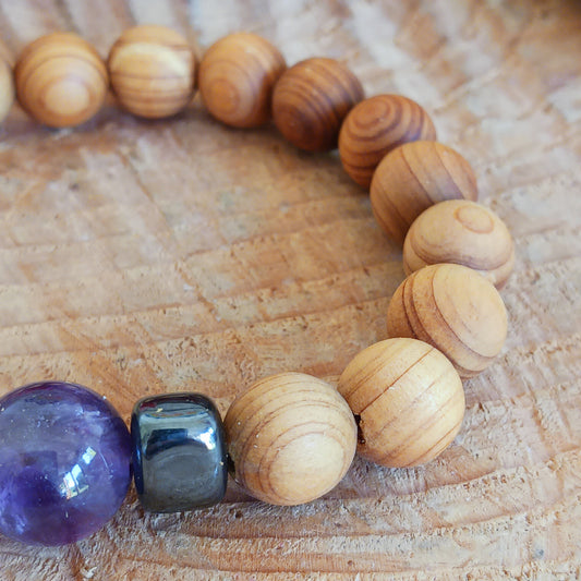 Embark on a journey of inner growth, intuition, and spiritual clarity with the Cedarwood Third Eye Chakra Bangle featuring Amethyst. This enchanting bracelet combines the grounding energy of natural cedarwood with the transcendent vibration of amethyst, a stone renowned for awakening the Third Eye Chakra and enhancing spiritual awareness.
