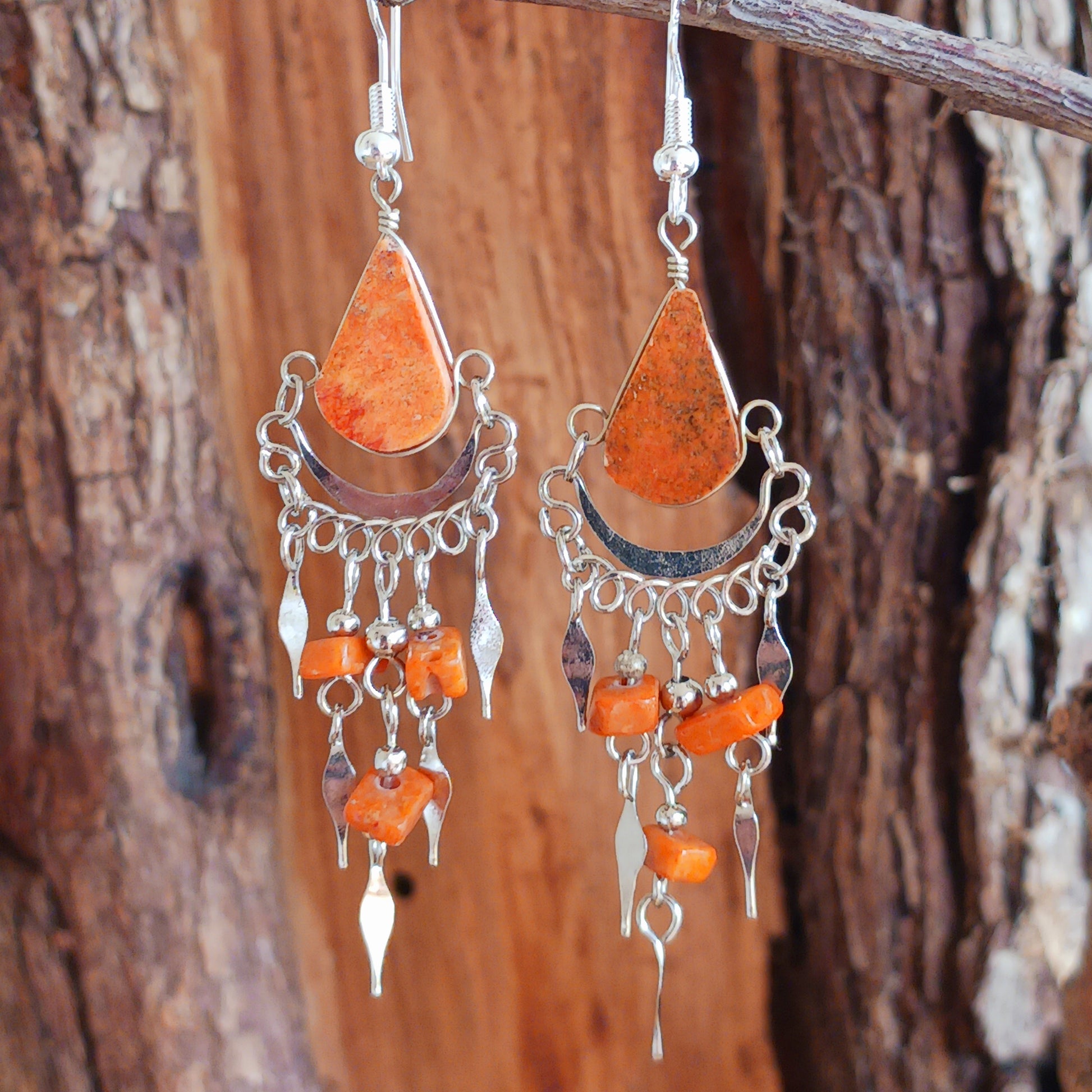 Add a touch of bohemian beauty to your look with these handmade Peruvian stone earrings. Featuring orange stones and finished with silver-plated hooks, each pair is carefully crafted in small workshops in Peru.
