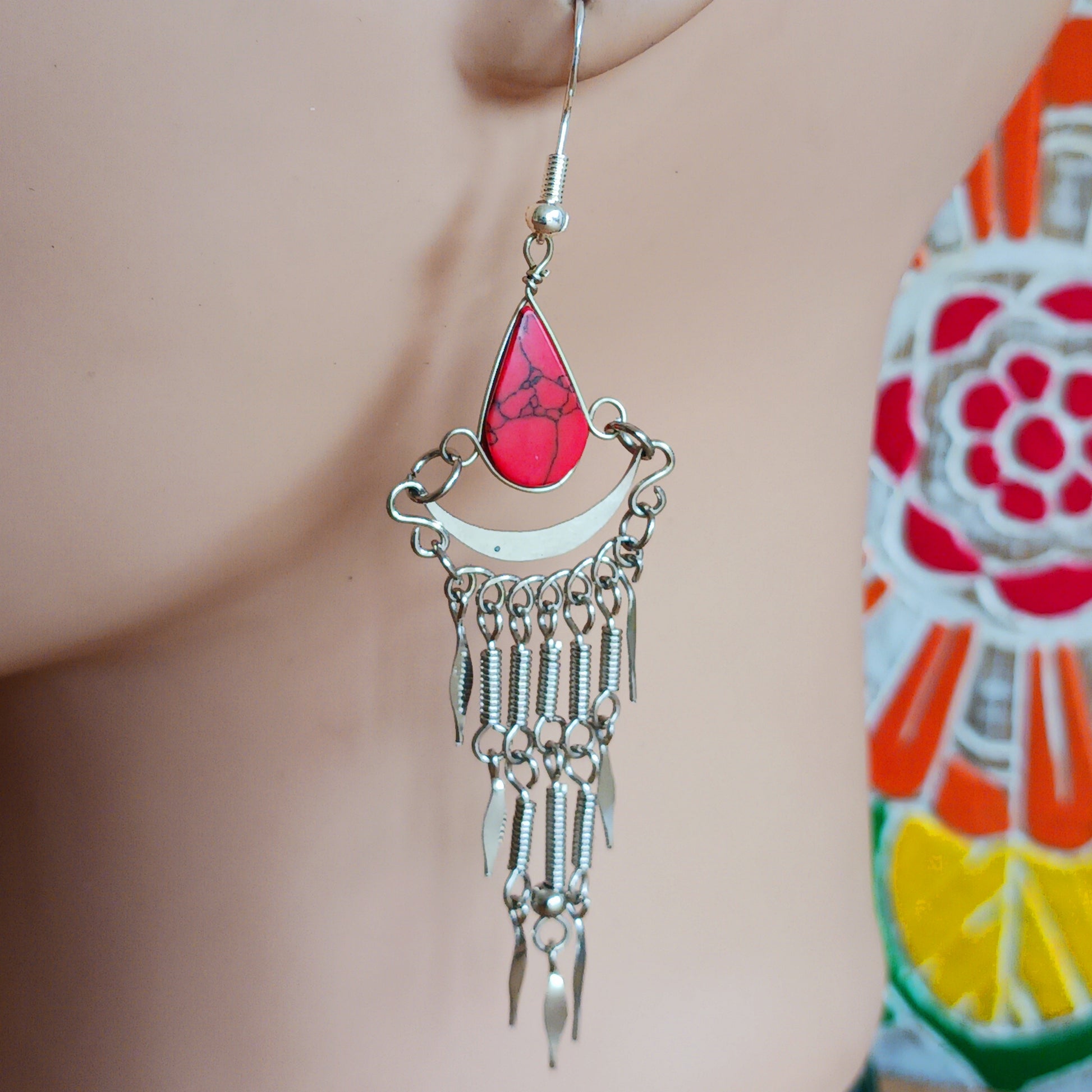Add a touch of bohemian beauty to your look with these handmade Peruvian stone earrings. Featuring red stones and finished with silver-plated hooks, each pair is carefully crafted in small workshops in Peru.
