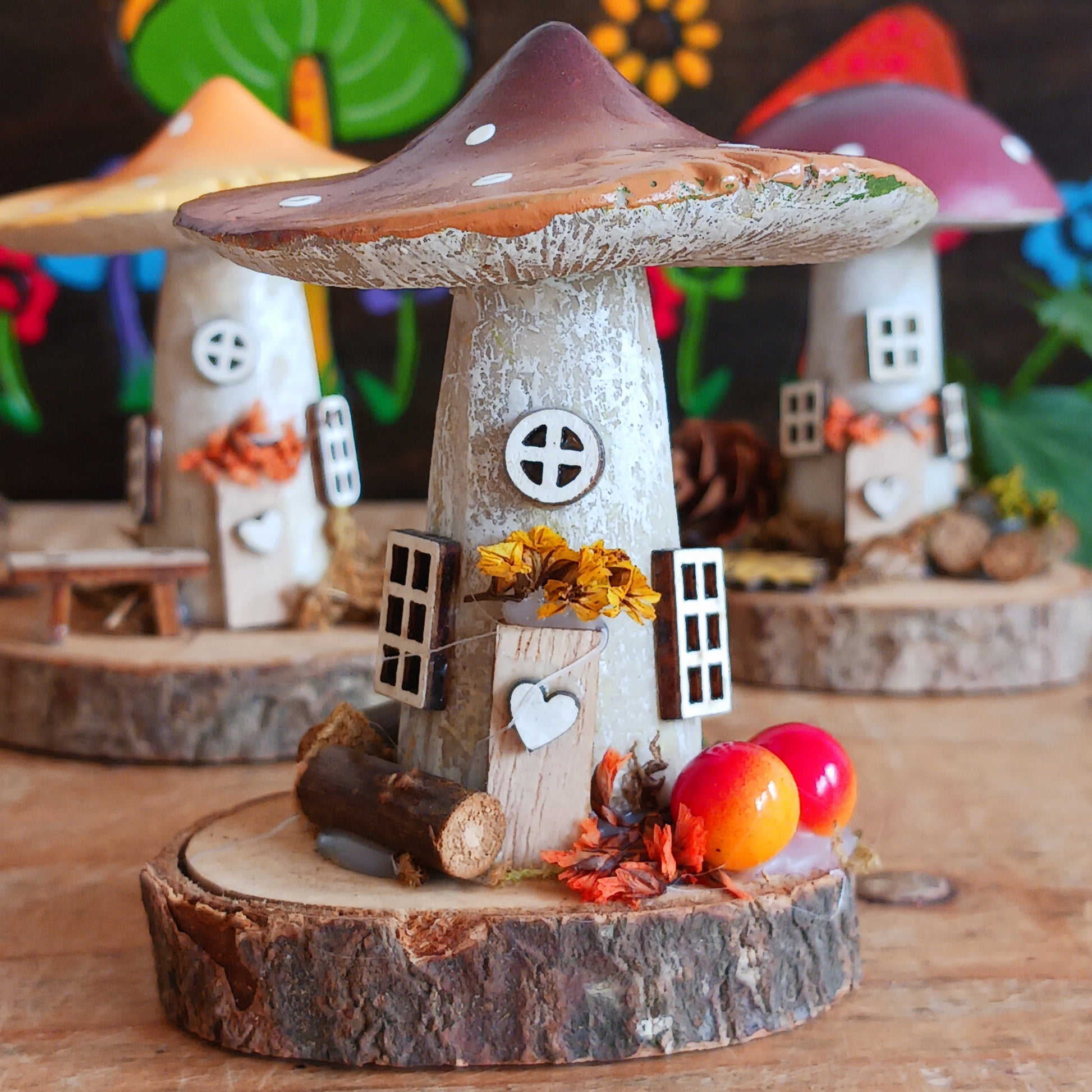 Add a whimsical touch to your home with these charming folk art mushroom cottages. Perfect for all occasions, these handcrafted ornaments are made from high-quality polystone and wood, featuring delightful details and a rustic base made from natural wood slices. Whether placed on a shelf, desk, or windowsill, these miniature cottages bring warmth and personality to any space. Ideal for gifting or as a unique addition to your home décor collection.