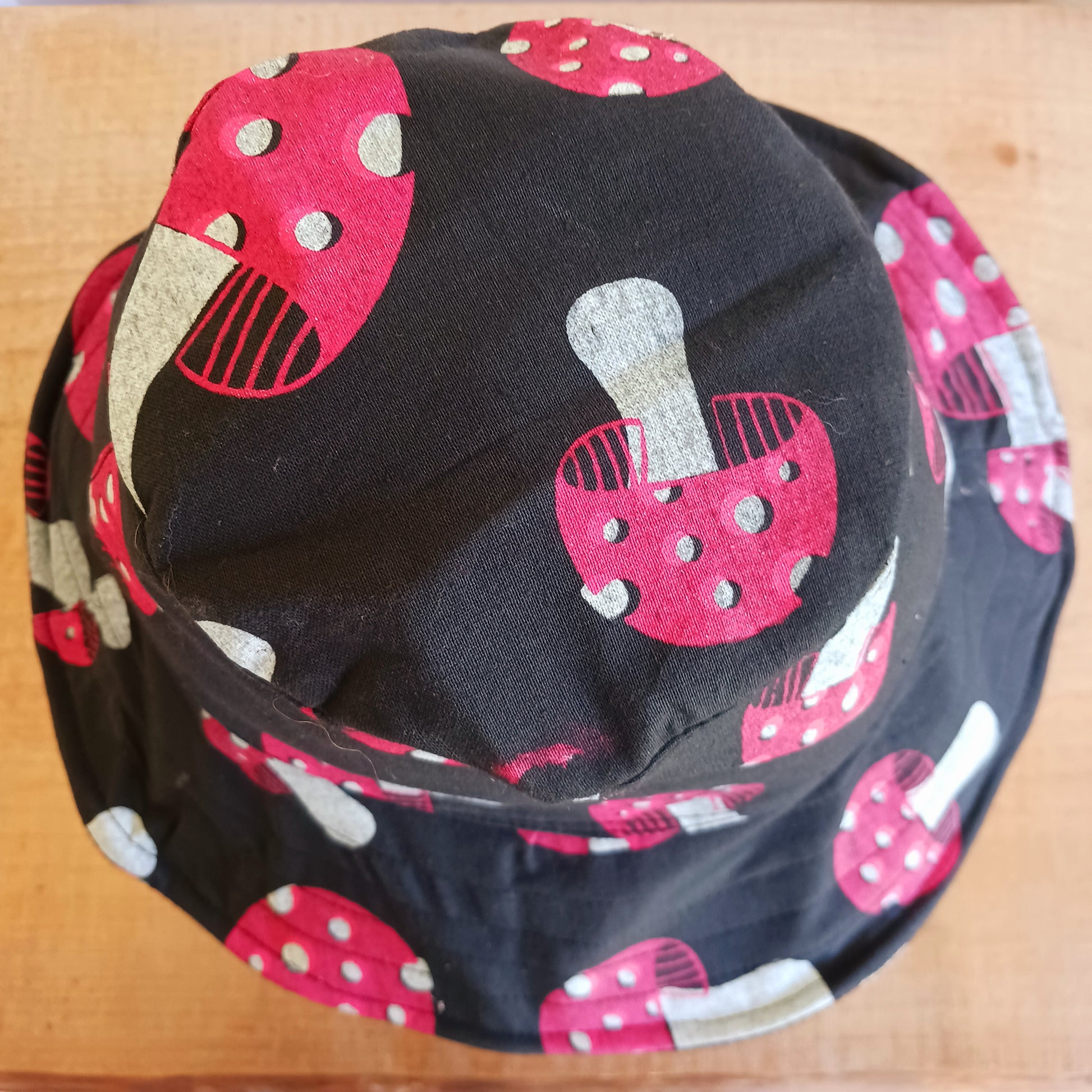 Stand out from the crowd with this lightweight Festival Mushroom Print Bucket Hat. Designed for festival season, holidays, beach days, and everyday summer wear, this stylish bucket hat features a bold all-over mushroom print that adds a fun, eye-catching touch to any outfit.