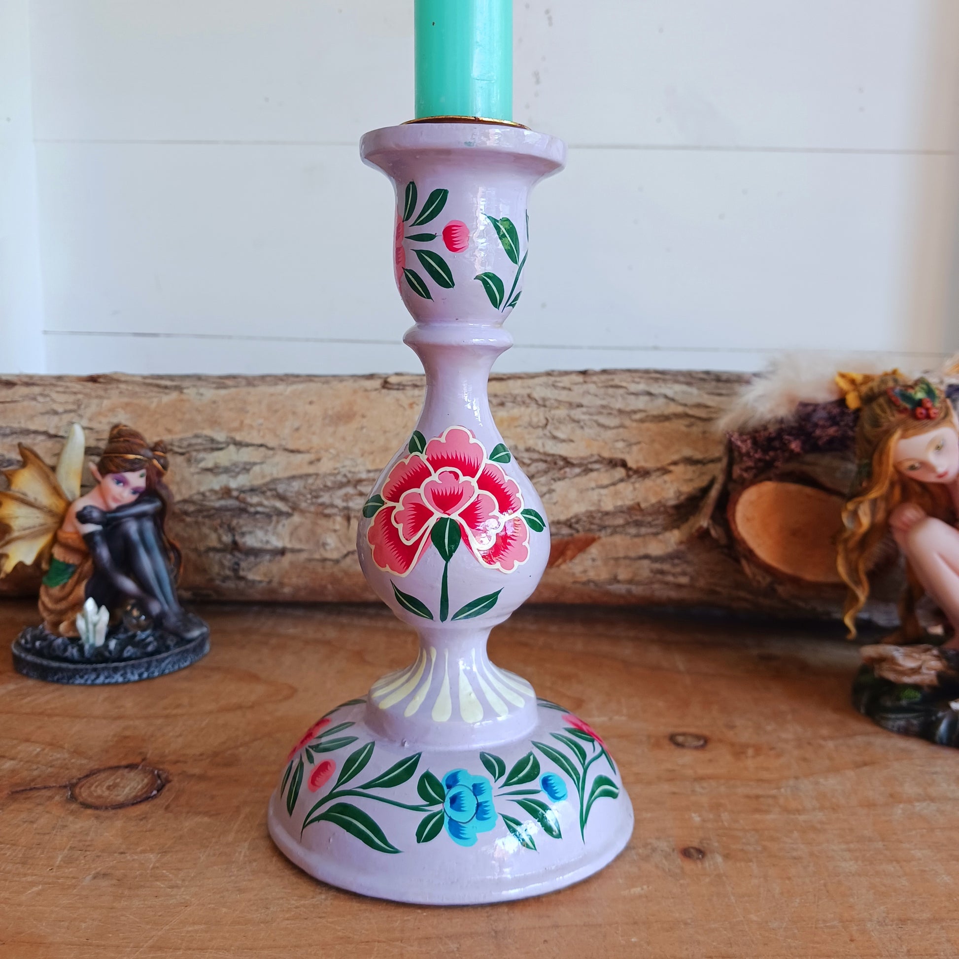 These beautifully hand crafted Kashmiri candle holders have been hand painted in four vibrant, decorative colours of purple, pink, yellow and turquoise.&nbsp; These unique candlesticks will fill any space with elegant grandeur.&nbsp; Intricate flower petals and delicate foliage are finished to a high shine glaze to boost the intensity of a captivating design.