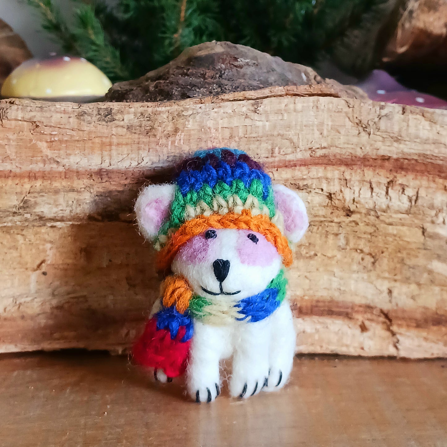 Bring instant festive cheer to your home with this adorable Christmas Tree Rabbit Decoration. Dressed in a hand-knitted rainbow hat and matching scarf, this charming little bunny captures the magic of the season at first sight. Its sweet black nose, expressive eyes, and cartoon-like ears bring out the childlike joy in anyone who sees it.